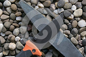 Survival folding knife with sharpener stone