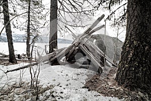 Survival lean-to in a winter forest with snow