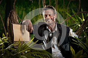 Survivor businessman leaning to a sign in the jungle