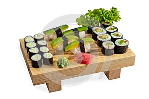 Sushi avocado set and sushi roll on wooden board isolated on white background