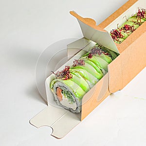 Sushi Box With Delicate Sushi Roll on a Plate