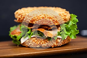 Sushi Burger with a variety of tasty ingredients on a dark background