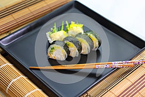 sushi on a ceramic plate in a traditional asian recipe
