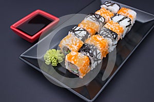Sushi Composition with Soy Sauce and Wasabi on Dark Background