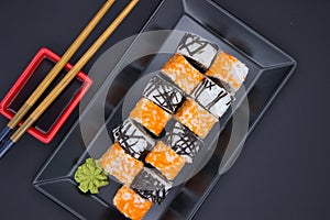 Sushi Composition with Soy Sauce and Wasabi on Dark Background