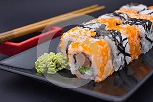 Sushi Composition with Soy Sauce and Wasabi on Dark Background