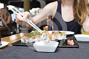 Sushi dipping in a soya sauce