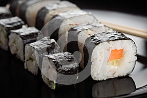 Sushi rolls on black dish