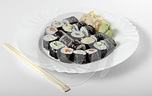 Sushi dish of traditional Japanese cuisine on a white plate, white background