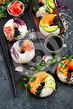Sushi donuts on a dark background.