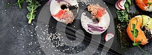 Sushi donuts on a dark background. Hybrid trend food