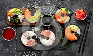 Sushi donuts on a dark background. Hybrid trend food