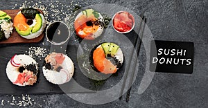 Sushi donuts on a dark background. Hybrid trend food