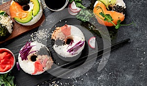 Sushi donuts on a dark background. Hybrid trend food