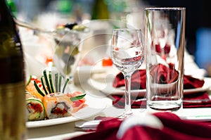 Sushi and glasses on a formal dining table