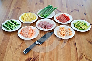 sushi ingredients placed on the wooden table. prepared for sushi making at home