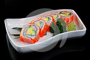 Sushi maki with avocado and shrimp eggs