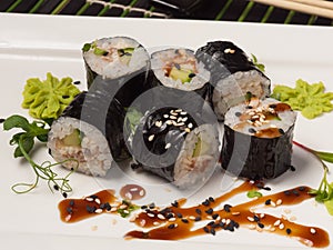 Sushi maki rolls with cucumber and eel with unagi sauce