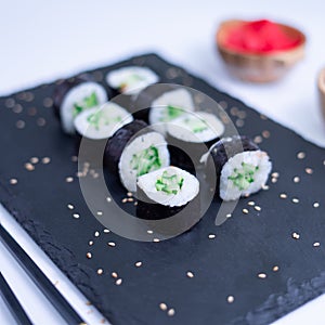 Sushi Maki rolls cucumber. Fresh hosomaki pieces with rice and nori. Close Up of delicious japanese food with sushi roll