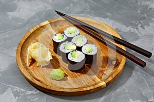 Sushi Maki rolls cucumber. Fresh hosomaki pieces with rice and nori. Close Up of delicious japanese food with sushi roll