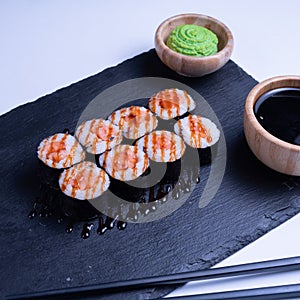 Sushi Maki rolls salmon. Fresh hosomaki pieces with rice and nori. Close Up of delicious japanese food with sushi roll