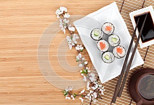 Sushi maki set with fresh sakura branch