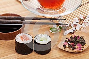 Sushi maki set, herbal tea and sakura branch