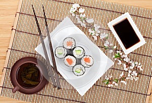 Sushi maki set with salmon and cucumber and green tea