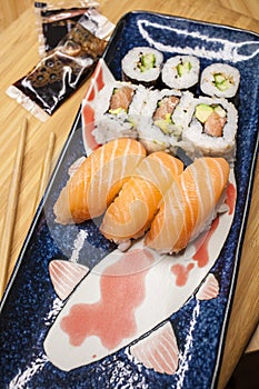 Sushi and makis served in a Japanese dish on a wooden background photo