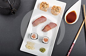 Sushi mix with sauces on a white tray photo