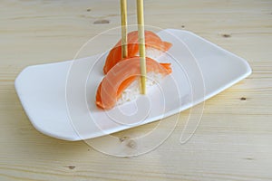 Sushi, nigiri, sake a dish of the traditional Japanese cuisine cooked from rice and a salmon.