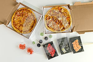 Sushi and pizza. Concept of business lunch, white background. Calorie food