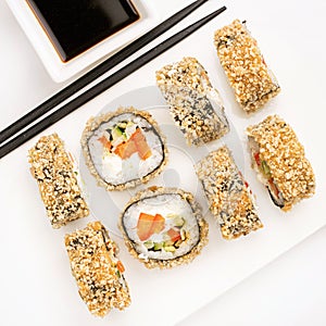 Sushi plate on white background, rolls set breading with vegetables on white background from above. Top view of