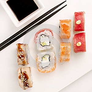 Sushi plate on white background, rolls set mix on white background from above. Top view of traditional japanese cuisine
