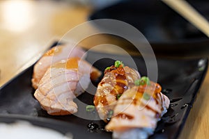 sushi, raw and grilled In the black plate