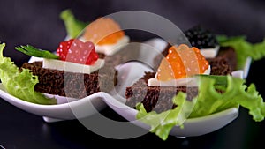 sushi with red black caviar served on a plate swirls in front of the camera close-up a lot of money wealth Luxury