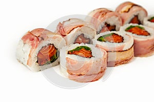 Sushi roll with bacon and salmon on a white background, ingredients seared bacon, salmon, green onions, flying fish roe, Iceberg