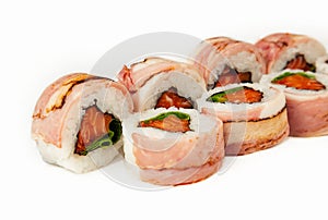 Sushi roll with bacon and salmon on a white background, ingredients seared bacon, salmon, green onions, flying fish roe, Iceberg