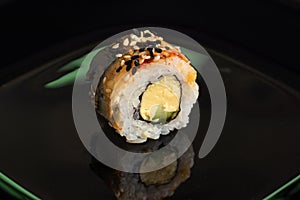 Sushi roll on a black background close-up. Sushi menu. Japanese food concept