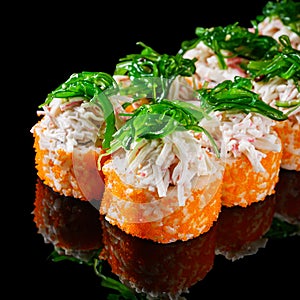 sushi roll with crab tobiko cucumber cream chukka cheese on a black mirror background