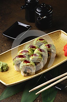 Sushi Roll with fish in a beautiful blue plate.