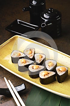Sushi Roll with fish in a beautiful blue plate.