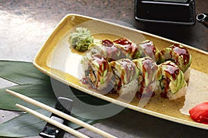 Sushi Roll with fish in a beautiful blue plate.