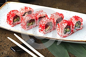 Sushi Roll with fish in a beautiful blue plate.