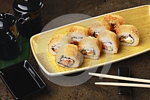 Sushi Roll with fish in a beautiful blue plate.