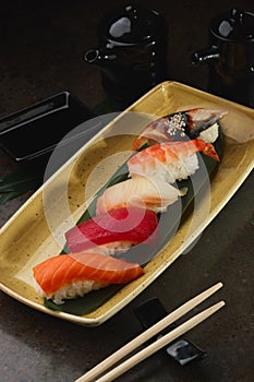 Sushi Roll with fish in a beautiful blue plate.