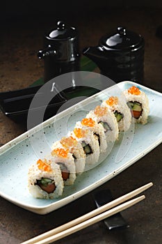 Sushi Roll with fish in a beautiful blue plate.