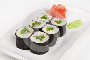Sushi roll with fish and green salad.