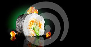 Sushi roll japanese food over black background. Sushi roll with tuna, vegetables, flying fish roe and caviar closeup