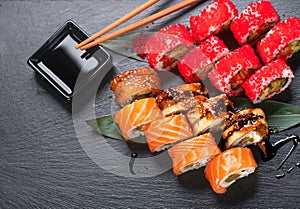 Sushi roll japanese food in restaurant. California Sushi roll set with salmon, vegetables, flying fish roe and caviar